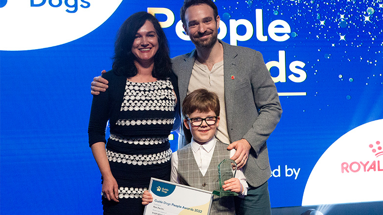 Deborah Bourne Director of Fundraising with actor and host Charlie Cox presenting an award to Rex Davies winner of the Inspirational Young Person of the Year and Overall Service User
