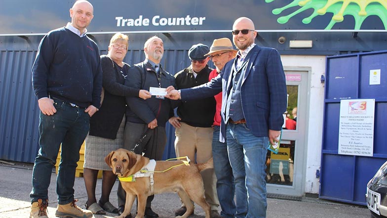 Beyond Surface Solutions presenting a fundraising cheque for Guide Dogs