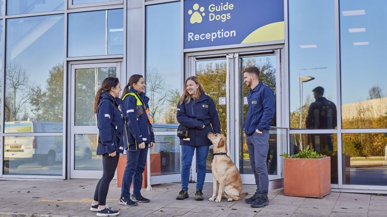 Guide dog learning specialists outside the academy building