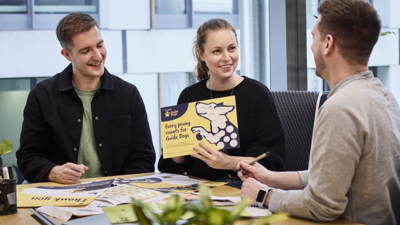 Colleagues in an office looking at fundraising resources