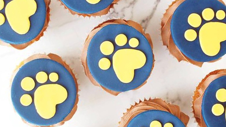 A selection of Guide Dogs paw print decorated cupcakes