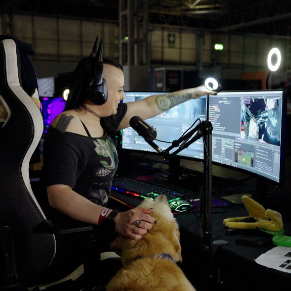Brutal Sue streaming at her computer next to her dog