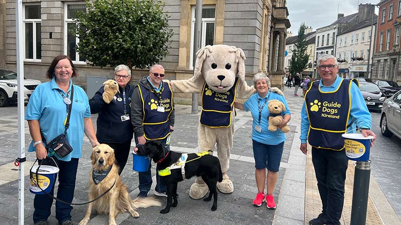 A group of Guide Dogs volunteers with collection buckets