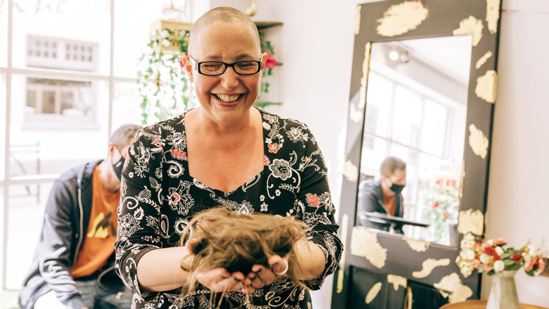 A fundraiser who has shaved her head for Guide Dogs