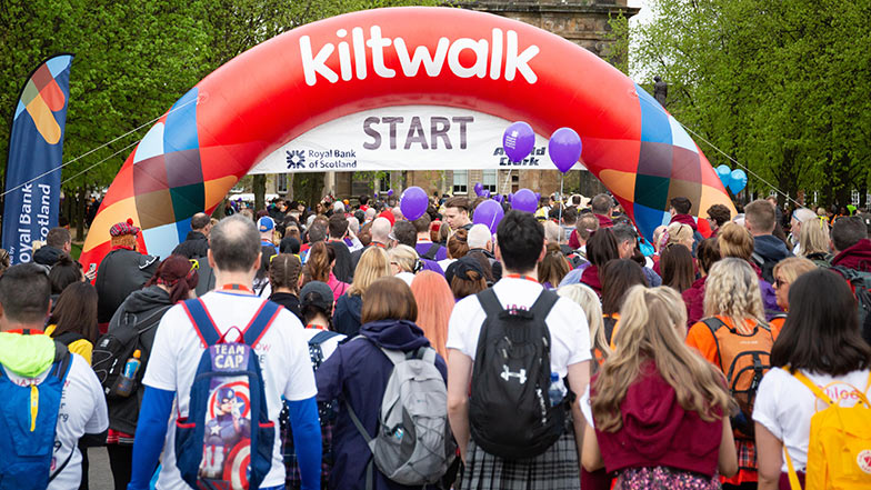 Groups of people crossing Kiltwalk starting line