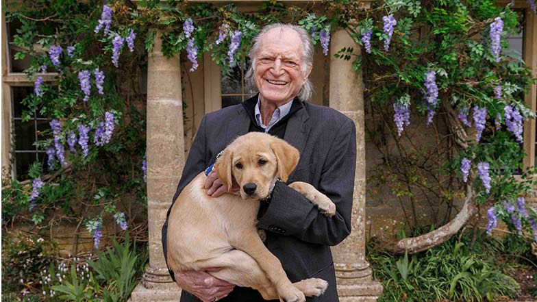 Guide Dogs Ambassador David Bradley with trainee guide dog Viola at the latest Omaze Million Pound House Draw 