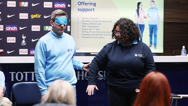 Sighted guide demonstration by two Guide Dog staff members