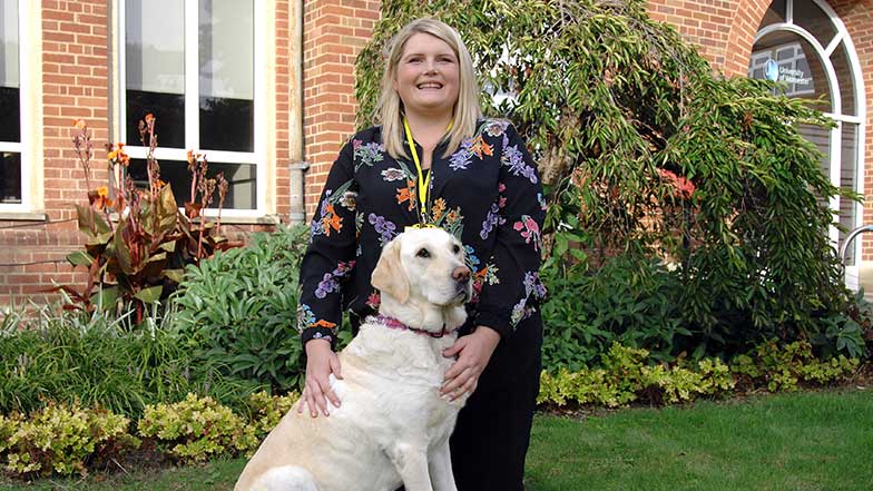 Guide dog owner sitting with her guide dog