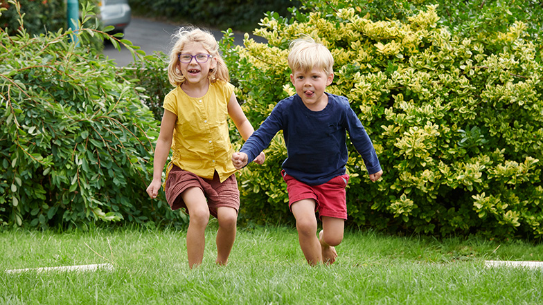 Josie and her brother Wolf running in the garden