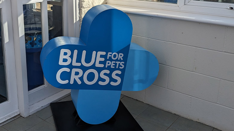 A sign in a sunny room which says 'Blue Cross for pets'.
