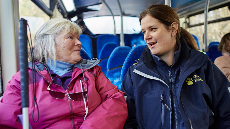 Service user Lynnette sitting on the bus with VRS, Rachael