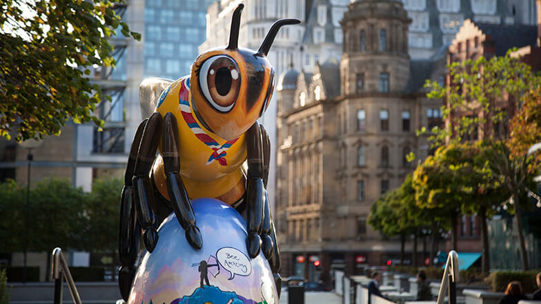 Close up front view of a decorated Bee sculpture in Manchester city centre.
