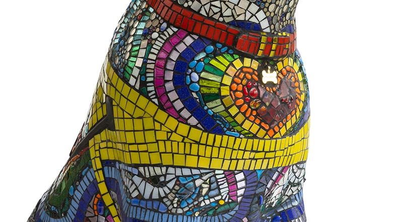 Close up of the sculpture's chest which is decorated in a rainbow coloured heart mosaic design.