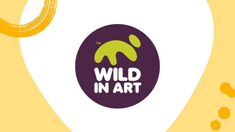 The Wild in Art purple and lime green partner logo on a white background with yellow paint splats