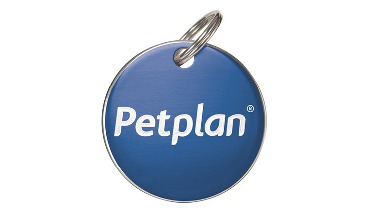 A round blue pet collar tag with a white Petplan logo in the centre