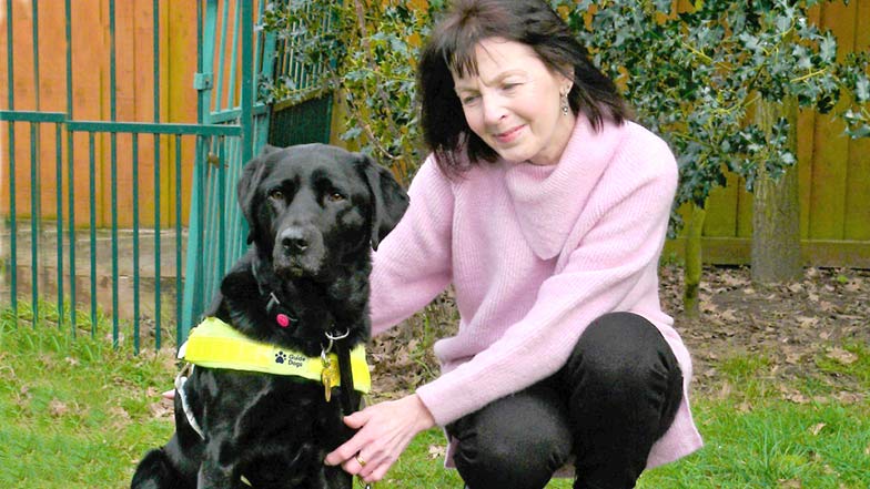 guide dog owner and guide dog sitting together outside