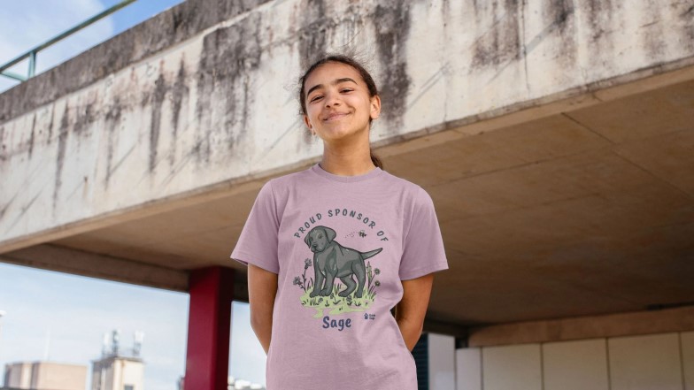 Smiling  young girl wearing her sponsored pup Sage t-shirt.