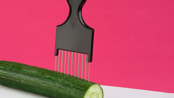 A comb in a cucumber to be used to help chop evenly