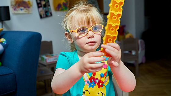 A young girl with a toy in her hand