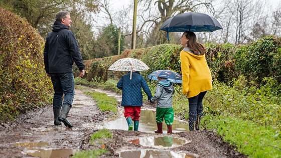 A family on a country walk in the rain