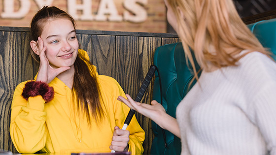 Mia smiling in a restaurant with her friends