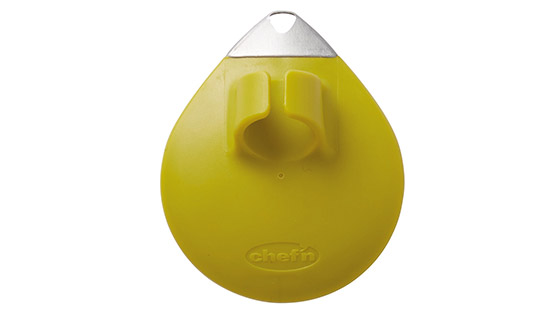 A yellow palm peeler with a ring to go around your finger