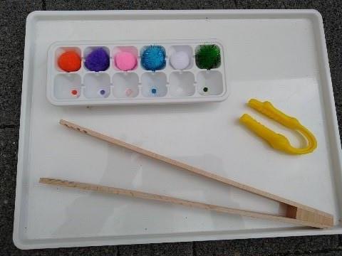 Tray with tongs and pom poms