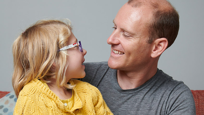 Picture of dad Roger and daughter Josie looking at each other and smiling