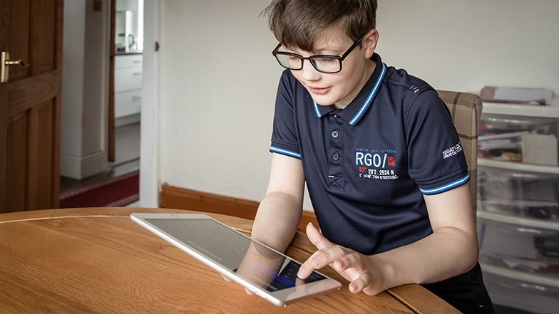 Boy typing on his Apple iPad