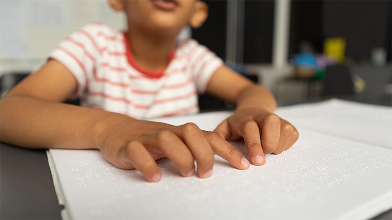 A child reading braille book