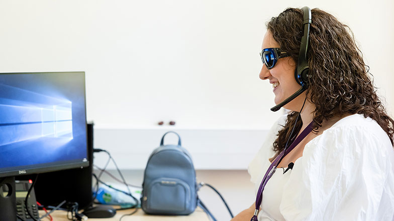 Cerys using over-ear headphones at work.