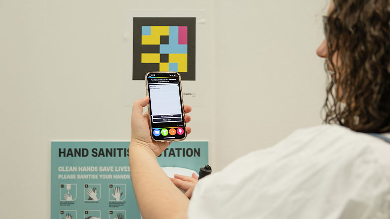 Cerys using the NaviLens app to scan a code.