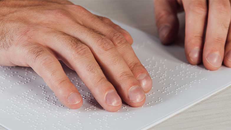 Hands reading braille 