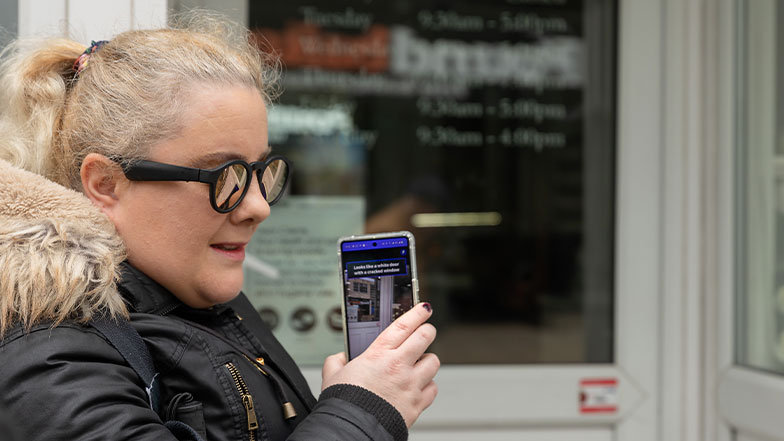 A vision impairment user using the Google lookout app to recognise the objects around her.