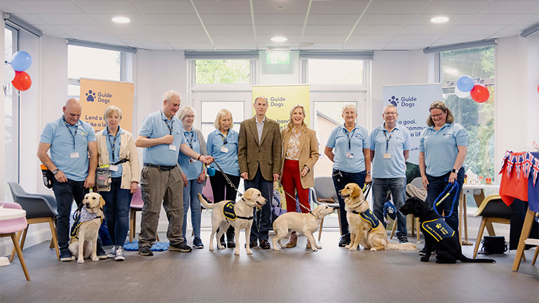 HRH The Duchess of Edinburgh attends a puppy class and is surrounded by volunteer puppy raisers and guide dog puppies