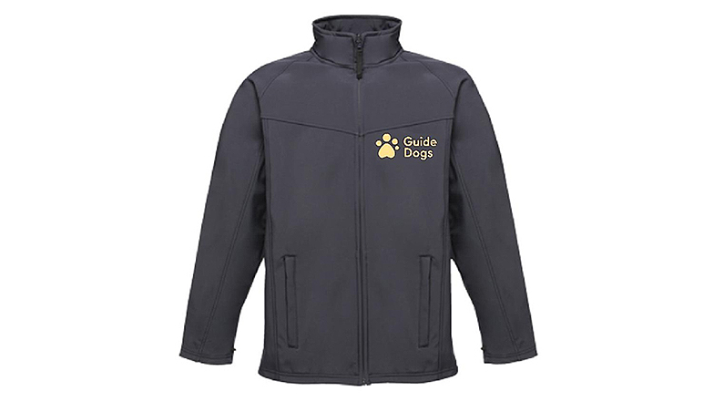 Black jacket with long sleeves and pockets. There is a pale yellow people paw logo and “Guide Dogs” wording on the left hand side of the chest.