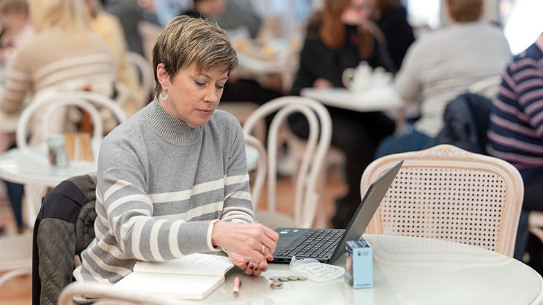 Volunteer fundraiser sits before a laptop