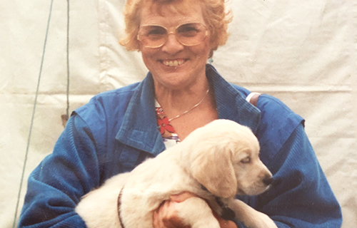 Cynthia holds her guide dog puppy