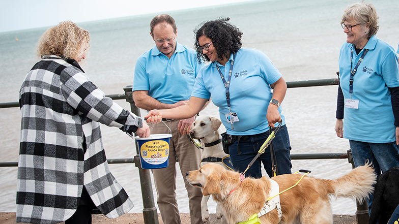 Guide Dogs fundraising volunteers with dogs and collection bucket